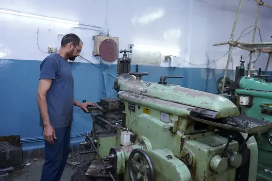A lathe on the TCR Engineering machine shop floor, cutting a test specimen from a client sample