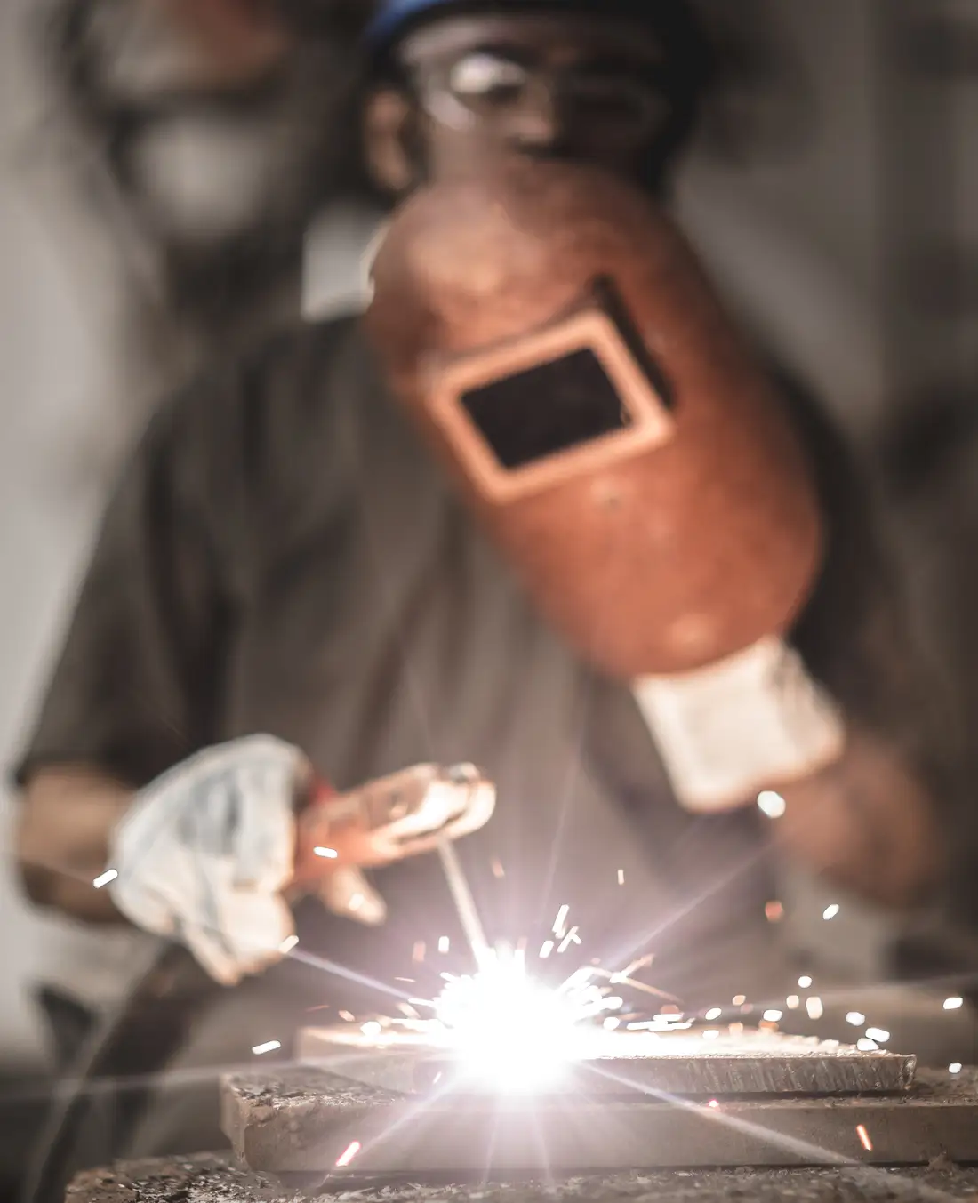 A welder depositing a test coupon in the qualification booth at TCR Engineering