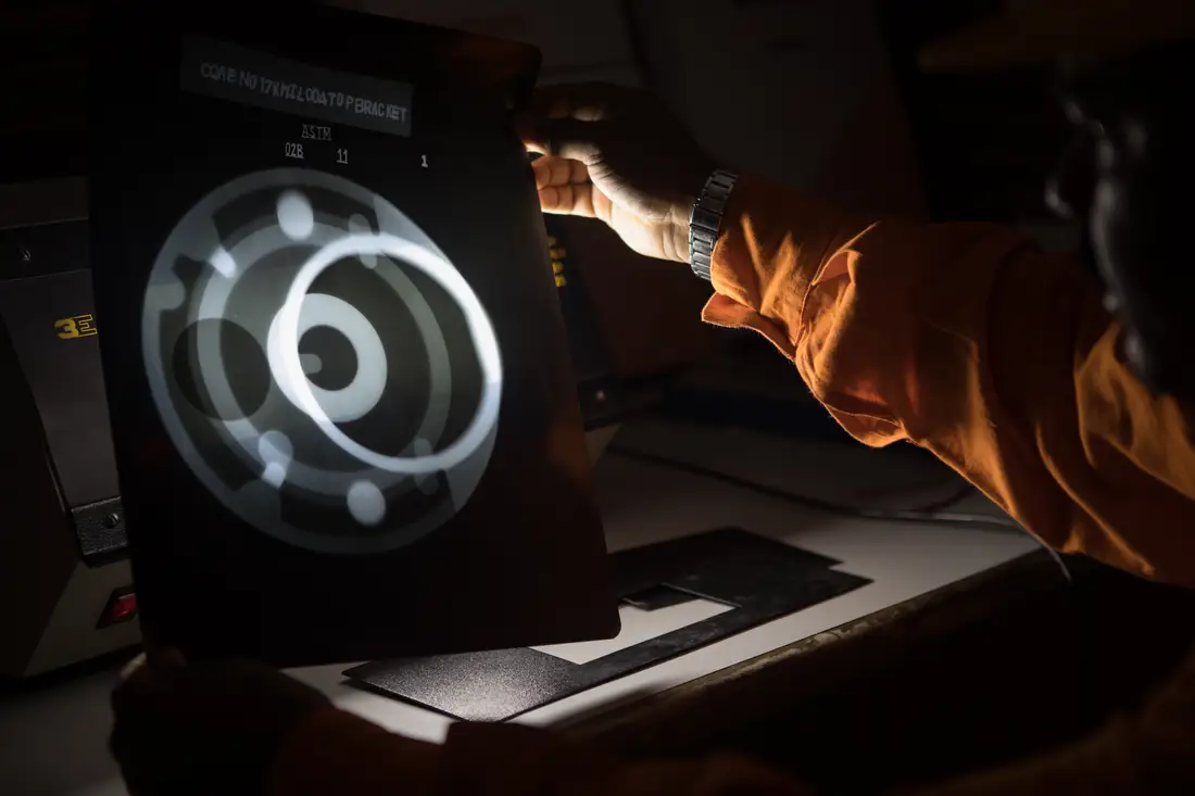 A radiographic film being interpreted on an illuminator by a TCR Engineering technician