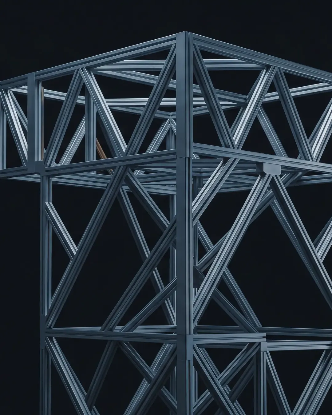 A precise, cold, machined aluminium lattice structure against a black seamless ground, edges catching hard cold light